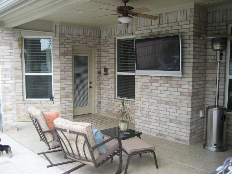 Covered patio with outdoor television and lounge seating